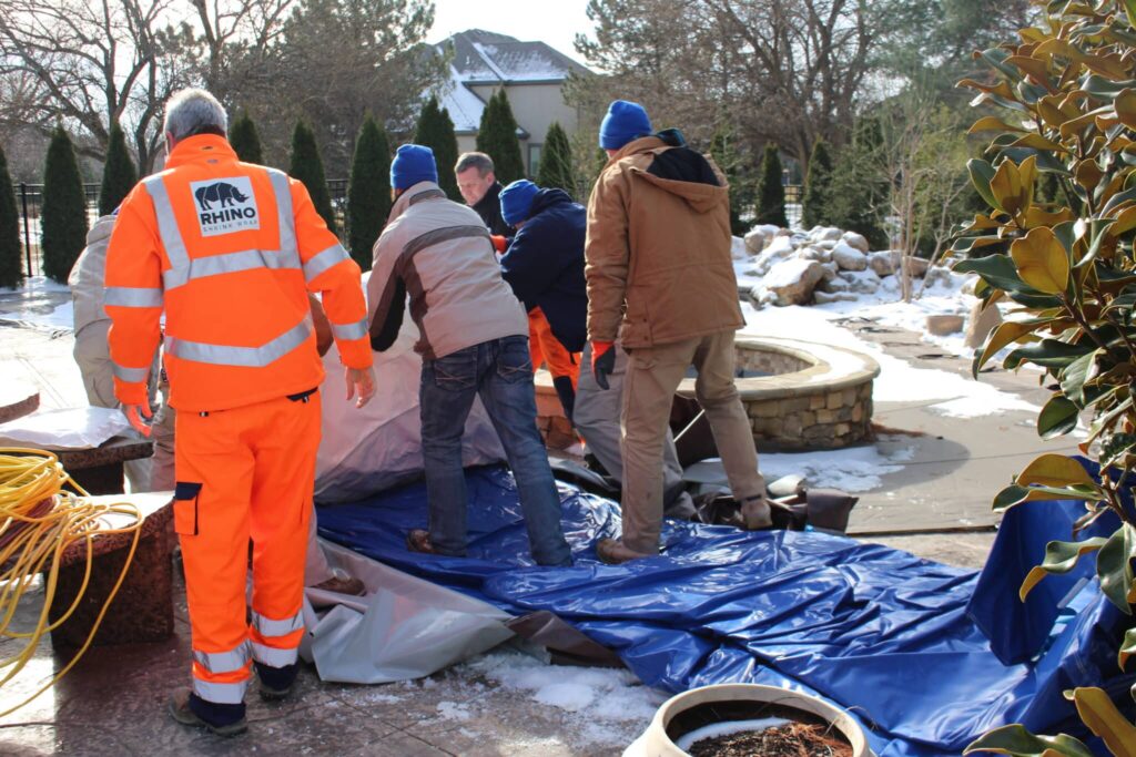 Installation crew unpacking the Njordair Fast Tent beside the pool site