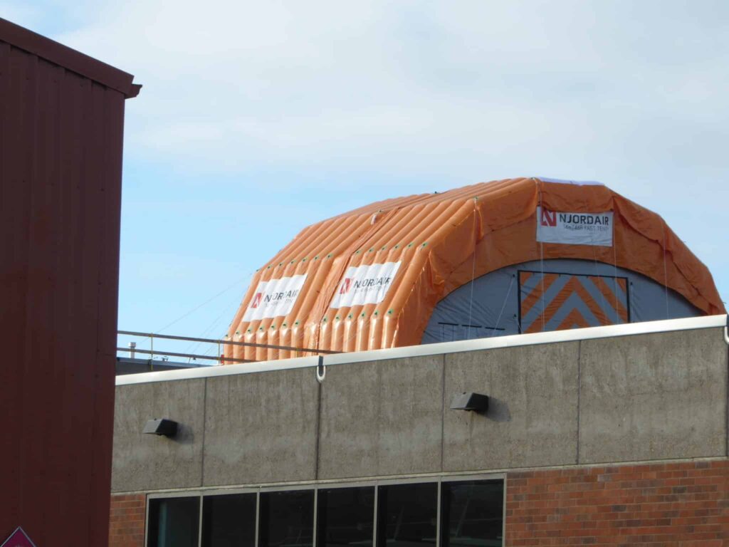 Njordair inflatable work tent positioned at the roof edge of the Oregon building