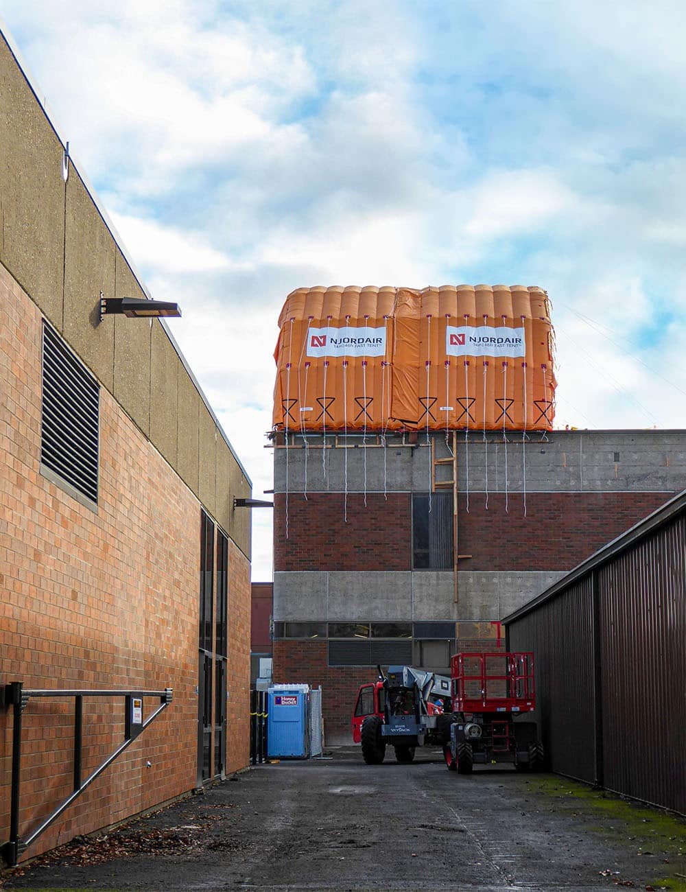 Roofing contractors linked multiple CA-10 units to create sheltered workspace, allowing operations through rain & high winds.