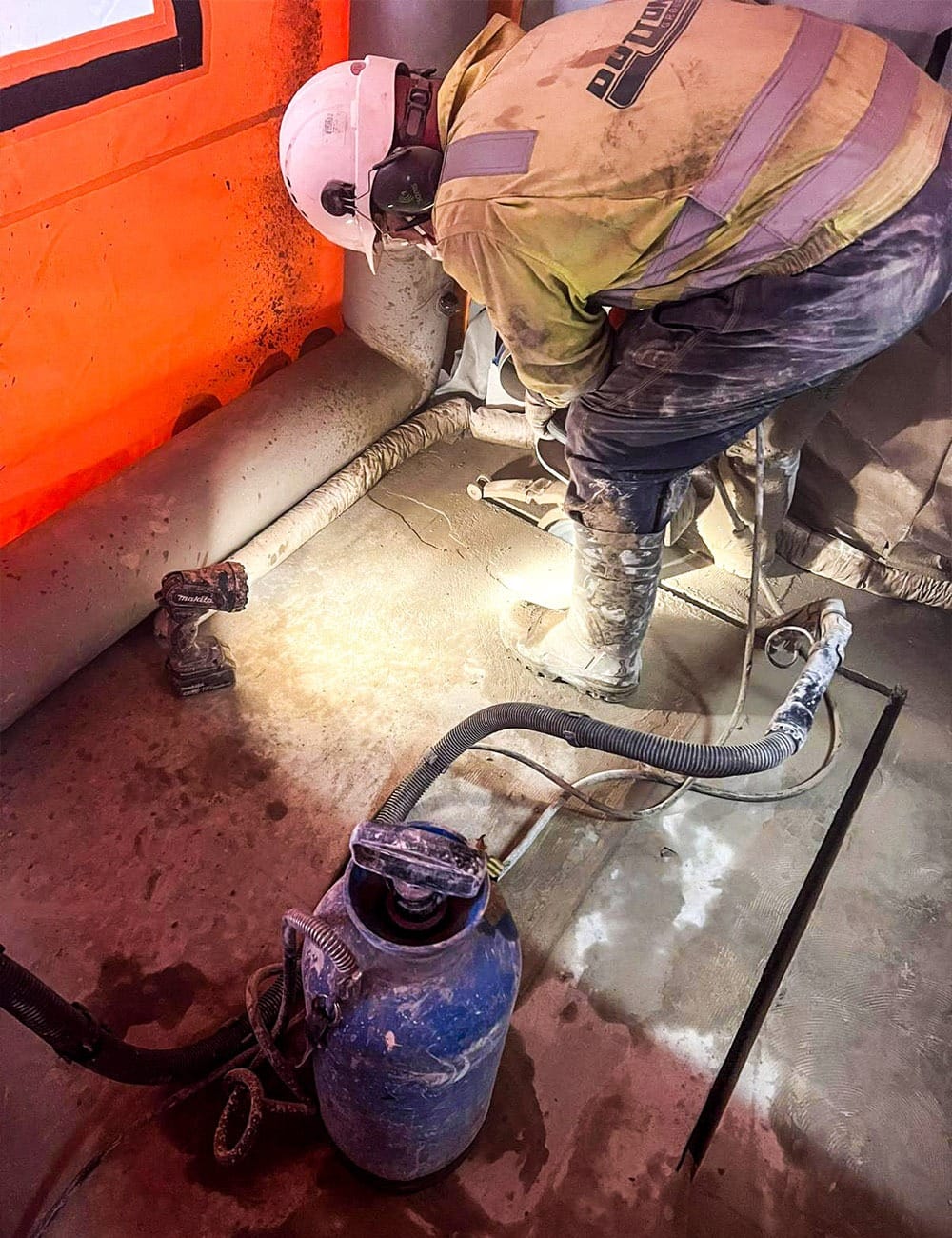 Sealed-air tent formed an enclosed area during concrete cutting, preventing dust from spreading into sensitive production zones.