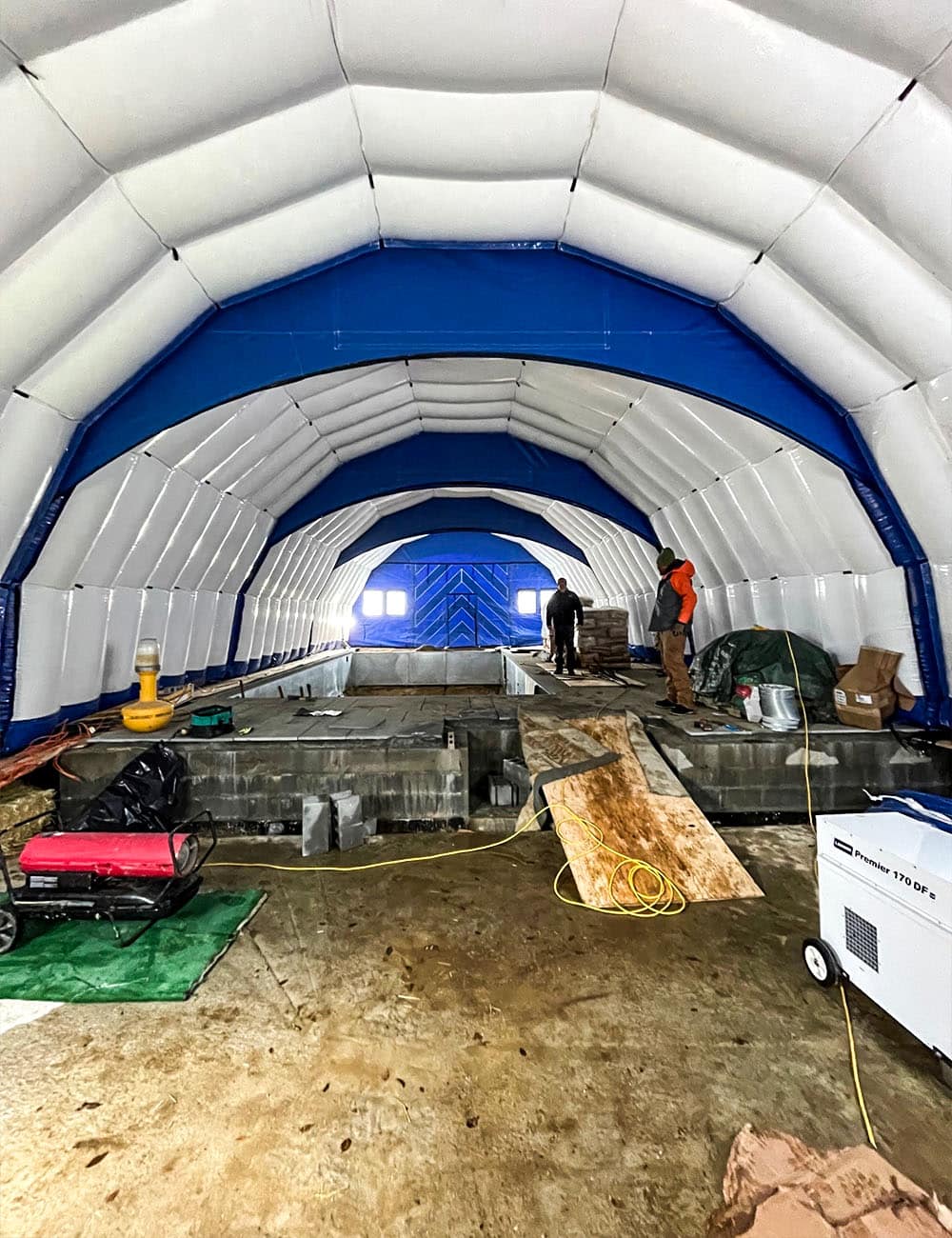 Njordair Fast Tent provided heated enclosure over winter pool install, shielding from snow, wind & cold, enabling safe, efficient work.
