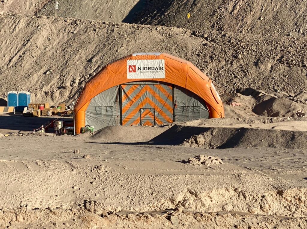 Orange Njordair enclosure set against the excavated hillside at the Chilean mine
