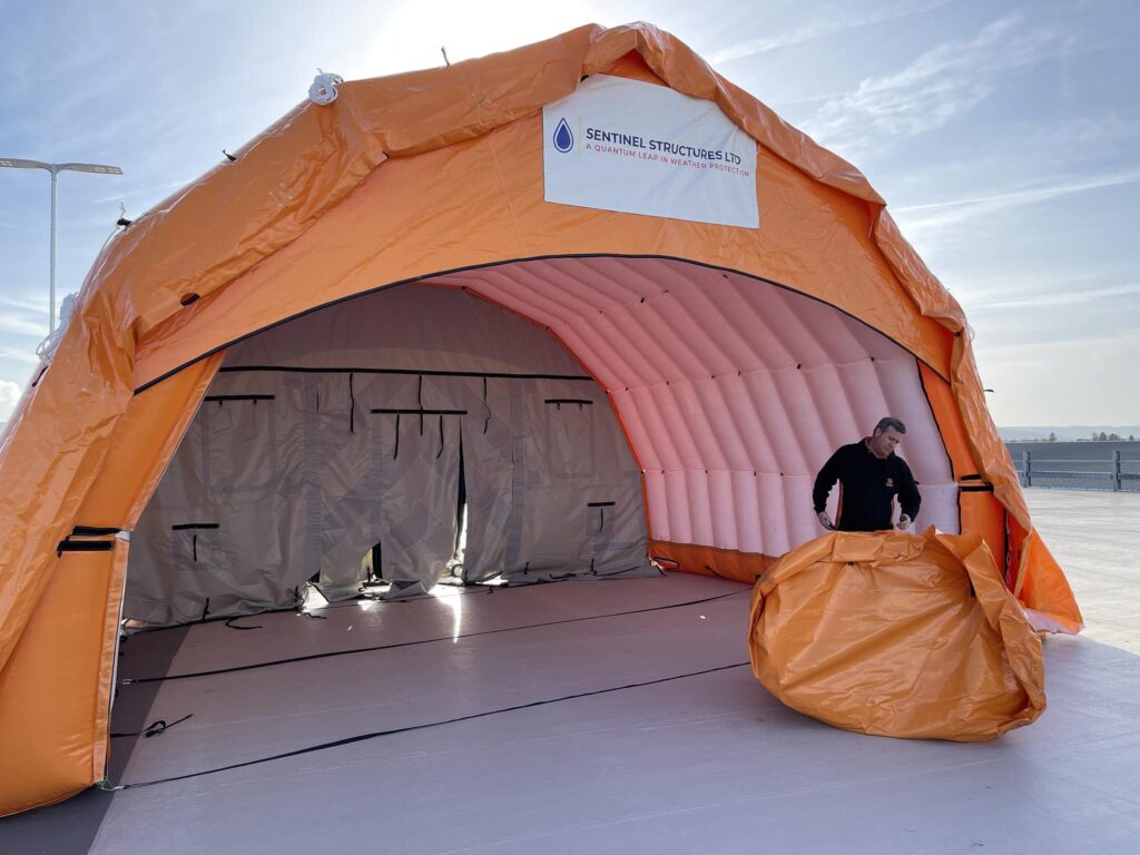 Open end of the Njordair tent showing the dry working area over the car park surface