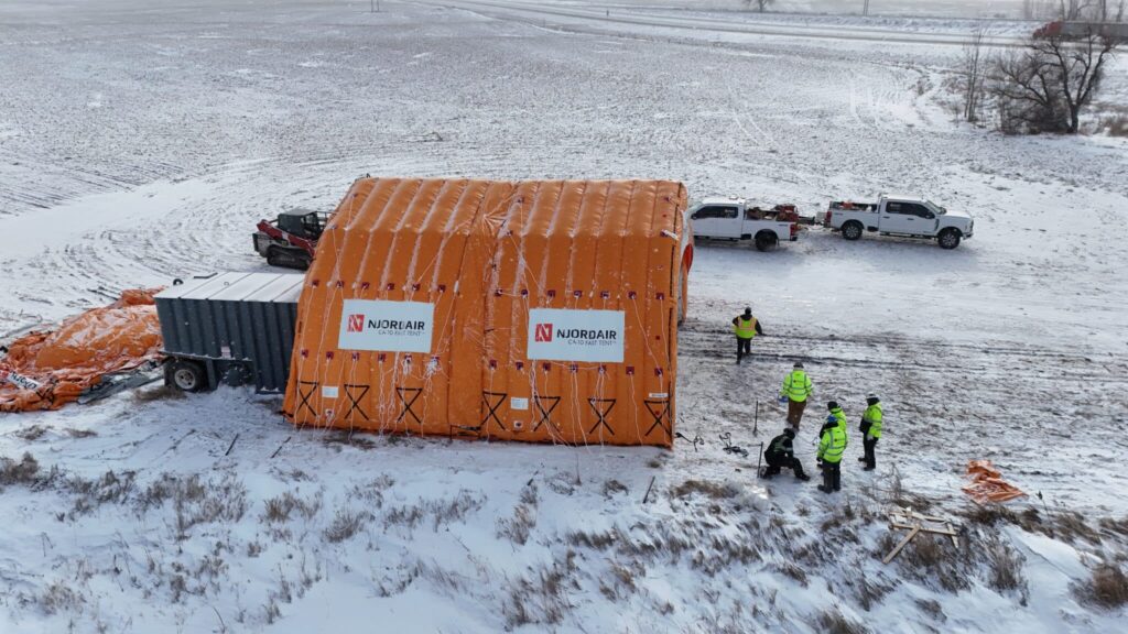 Completed Njordair thawing enclosure with crew and equipment on the snow-covered Stanton site